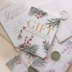 Stylish arrangement of holiday-themed gift certificates with envelopes and wax seals.